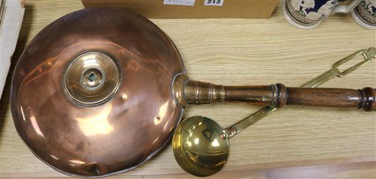 A Victorian copper warming pan and a brass ladle